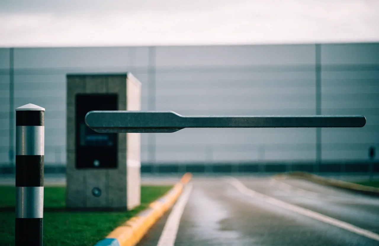 Boom gate arm and empty lane at an airport car park exit under overcast light